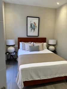 ein Schlafzimmer mit einem großen Bett mit zwei Lampen in der Unterkunft Suspiro 201 Elegant Suite in Granada