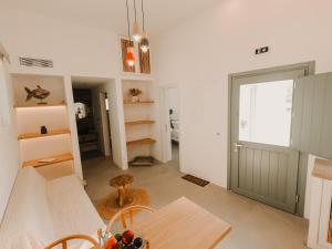 a kitchen with a table and a dining room at Venue Villas - Folegandros in Áno Meriá