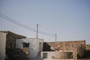 two stone buildings with a sky in the background at Venue Villas - Folegandros in Áno Meriá