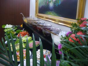a buffet with many plates of food and flowers at Lyon Hotel İstanbul in Istanbul