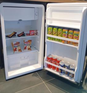 an open refrigerator filled with lots of food and drinks at Balnéo SPA Allevard in Allevard