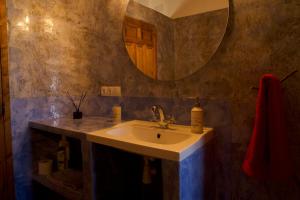 a bathroom with a sink and a mirror at Cortijo Los Llanos in Huéscar +57 photos