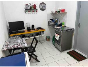 a kitchen with a counter and a stove and a table at Betesda 2197F in São Luís +7 photos