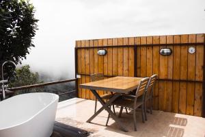 a table and chairs on a balcony with a bath tub at Oasis Yurt Villa @ Doi Lan - โอเอซิส เยิร์ต วิลล่า @ ดอยล้าน in Ban Huai Khai +143 photos