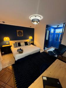 a hotel room with a bed and a desk and chair at The Blue Suite in Fuengirola +22 photos