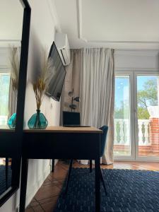 a desk with a computer in a room with a window at The Blue Suite in Fuengirola