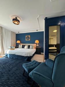 a bedroom with a large bed and a chair at The Blue Suite in Fuengirola +28 photos