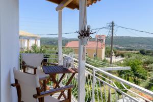 a balcony with a table and chairs and a view at Golden Navarino's Sunset in Pylos