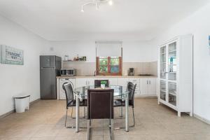 a kitchen with a glass table and chairs at Villa Cassis in Adeje