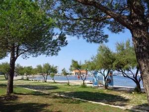 a park with trees and a body of water at Apartment Tereza in Sukošan