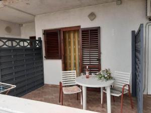a white table and chairs on a patio at Apartment Tereza in Sukošan