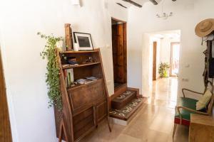 a room with a book shelf and a hallway at Cortijo Los Llanos in Huéscar