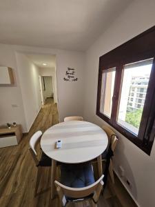 a room with a table and chairs and a window at Ático Alameda in Santa Cruz de la Palma