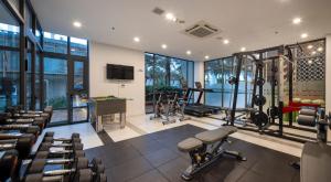 a gym with treadmills and equipment in a building at Le Palmier Ho Tram Resort - Beachfront with Private Beach in Ho Tram
