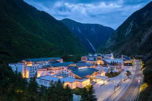 a resort in the mountains at night at Lebanshan Hotel Jiuzhai Valley in Jiuzhaigou