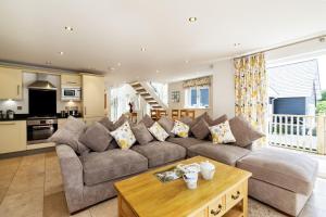 a living room with a couch and a table at Trewhiddle Retreat V27 by Together Travel - Luxury 3-Bedroom Villa in St Austell