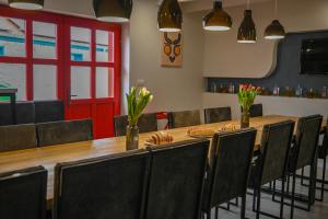 a conference room with a long table and chairs at Bohém Borklub in Tállya +105 photos