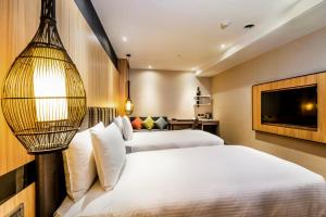 Postel nebo postele na pokoji v ubytování La Vida Hotel