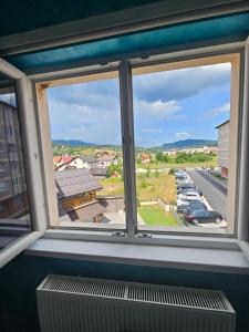 una ventana con vistas a un aparcamiento en Jovana stan na dan Pale, en Pale