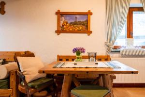 a dining room with a wooden table and chairs at Kmečka Hiška - Hiša vina Cuk in Lendava