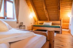 a bedroom with two beds in a log cabin at Kmečka Hiška - Hiša vina Cuk in Lendava +20 photos