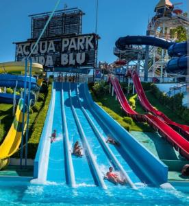 a group of people in the water at a water park at La Sirenetta in Tortoreto Lido