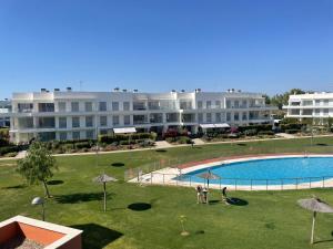 a view of a resort with a pool and buildings at Beach House Costa Ballena in Chipiona