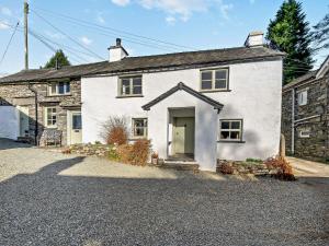 a white house with a door on a street at 3 Bed in Hawkshead 54193 in Hawkshead