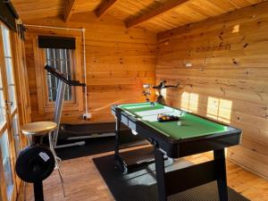 a room with a pool table in a log cabin at Luxury Jacuzzi Fast WIFI PS5 Gym Parking 2 spaces in Hereford