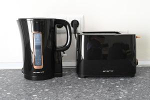 a microwave and a toaster oven sitting on a counter at Beach Apartment Μ in Nea Karvali