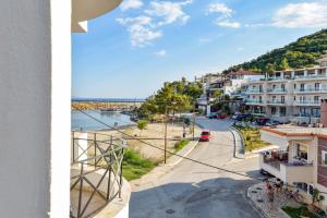 a view from a balcony of a street and buildings at Beach Apartment Μ in Nea Karvali