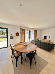 a living room with a wooden table and chairs at Villa en Provence avec piscine in Mollégès