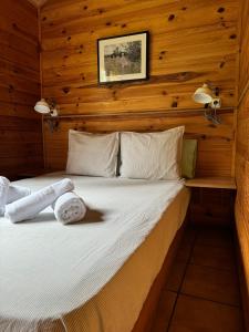 a bedroom with a bed in a wooden wall at Racons del Pedraforca in Saldés