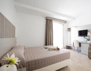 Postel nebo postele na pokoji v ubytování Forte 2 Hotel