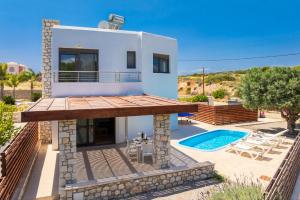 a villa with a swimming pool and a house at Villa Dias in Lachania