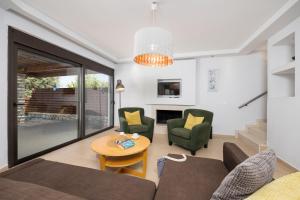 a living room with a couch and chairs and a table at Villa Dias in Lachania