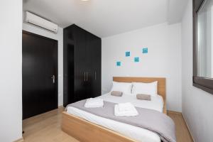 a bedroom with a large bed with two towels on it at Villa Dias in Lachania +17 photos