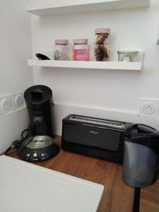 a kitchen counter with a coffee maker and a blender at Le havre de Paix Appartement T2 in Mazères