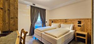 Postel nebo postele na pokoji v ubytování Albergo Alpenrose