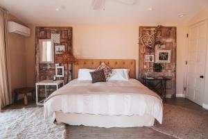 a bedroom with a large bed with a wooden headboard at The Outlaw By The Cohost Company in Pioneertown
