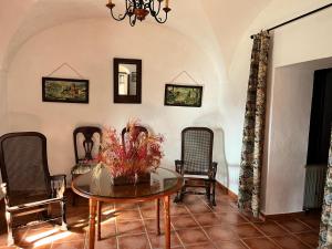 a dining room with a table and chairs at Casa Rural Cortijo Torres in La Parra