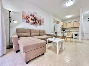 a living room with a couch and a table at Vivienda Carolina in Santa Cruz de Tenerife