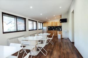 a dining room with white tables and chairs at Guesthouse Juli in Sapareva Banya