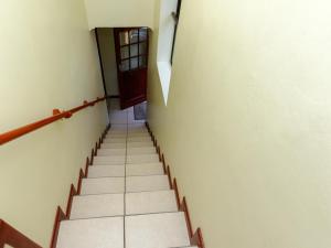 a staircase in a building with a door and a hallway at Ascot Gardens Self Catering in Cape Town