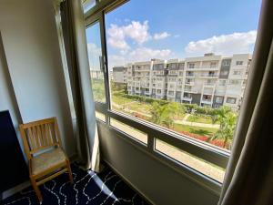 a room with a window with a view of a building at Luxe Home in Madinaty in Madinaty