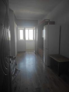 an empty room with a refrigerator and a window at Navy Sky View - Garsoniera confort I in Tulcea