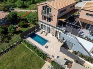 an aerial view of a house with a swimming pool at Argeno Suites Lefkada in Lefkada Town +114 photos