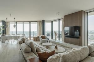 a living room with a large couch and a table at Enso District Residences in Knokke-Heist