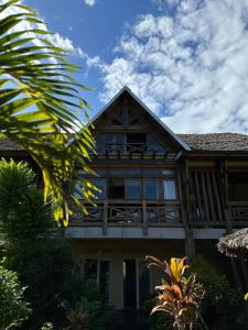 a house with a balcony on top of it at Trano Aloalo in Foulpointe