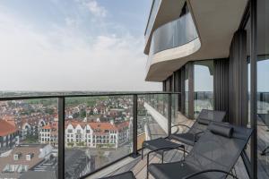 a balcony with chairs and a view of the city at Enso District Residences in Knokke-Heist